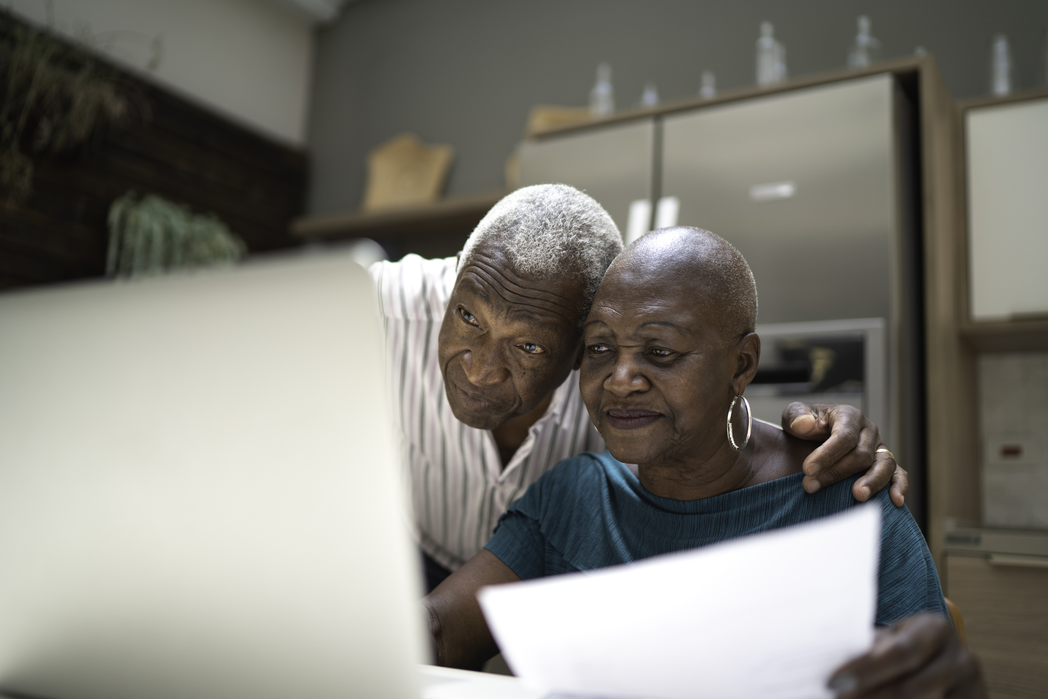 couple looking at a computer discussing what is on the screen