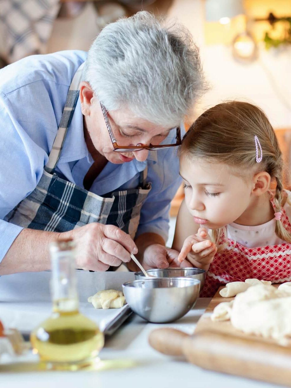 Resident cooking with granddaughter