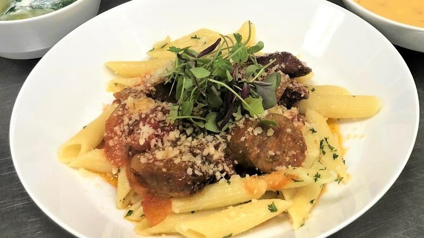 pasta with italian sausage on a plate