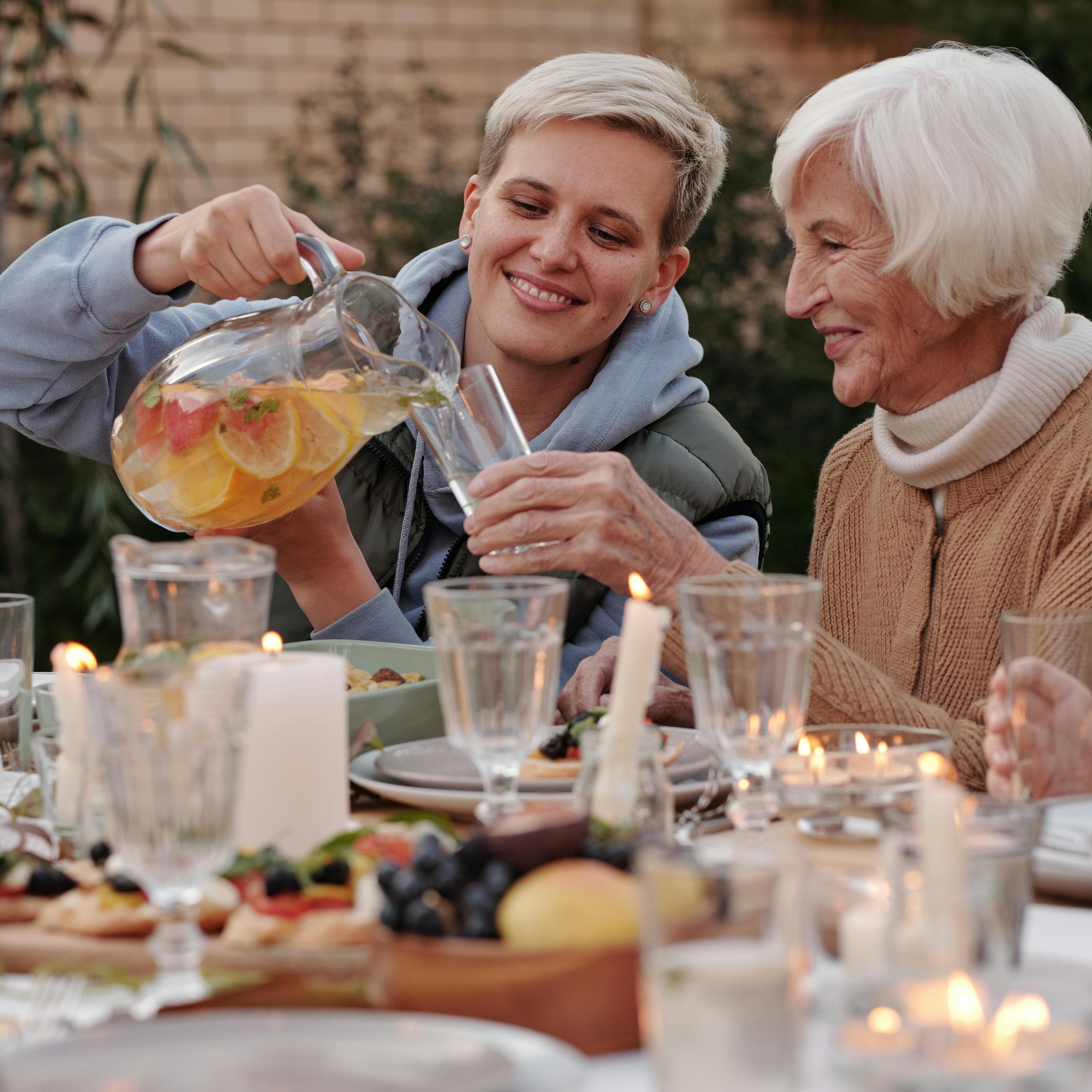 two women, one pouring the other a drink