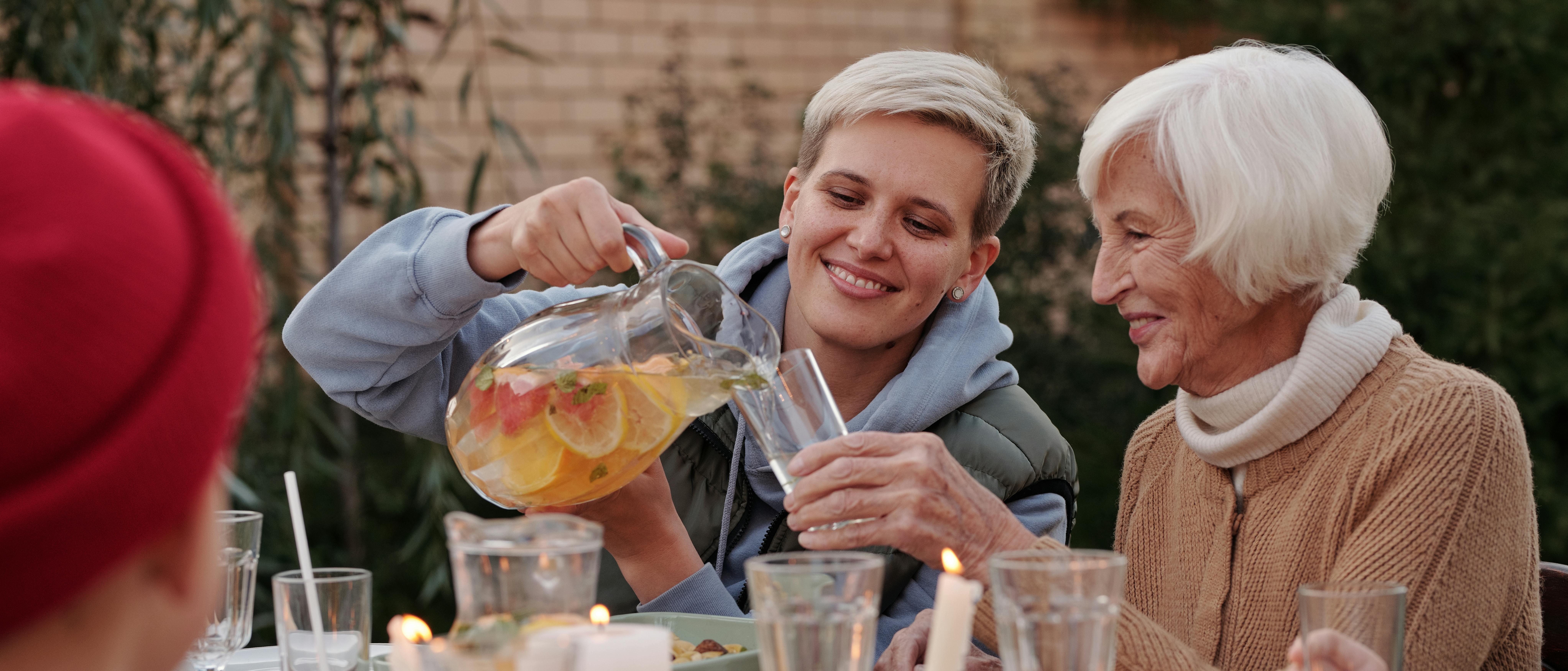 two women, one pouring the other a drink