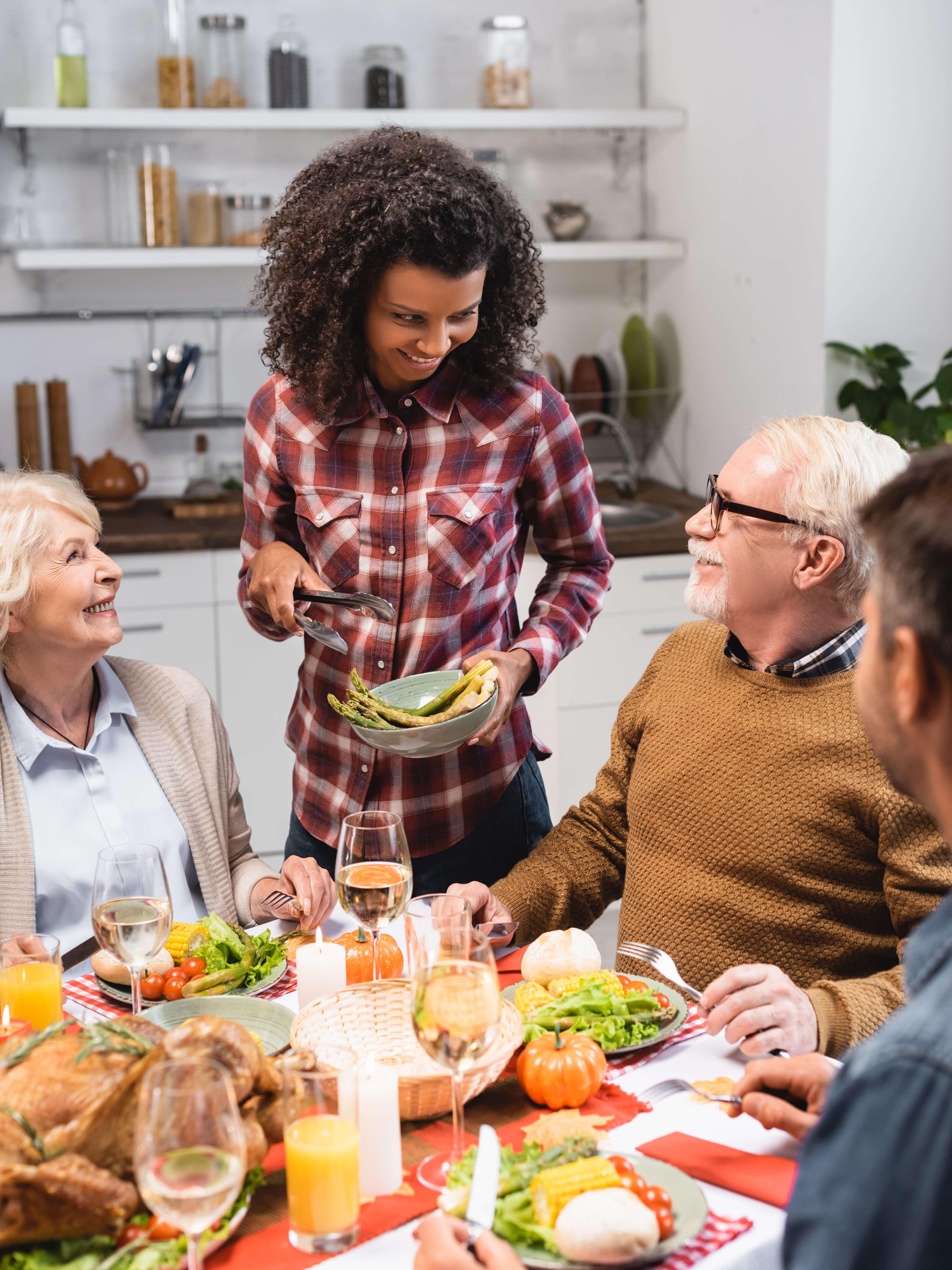 Caregiver serving a meal to a group of residents