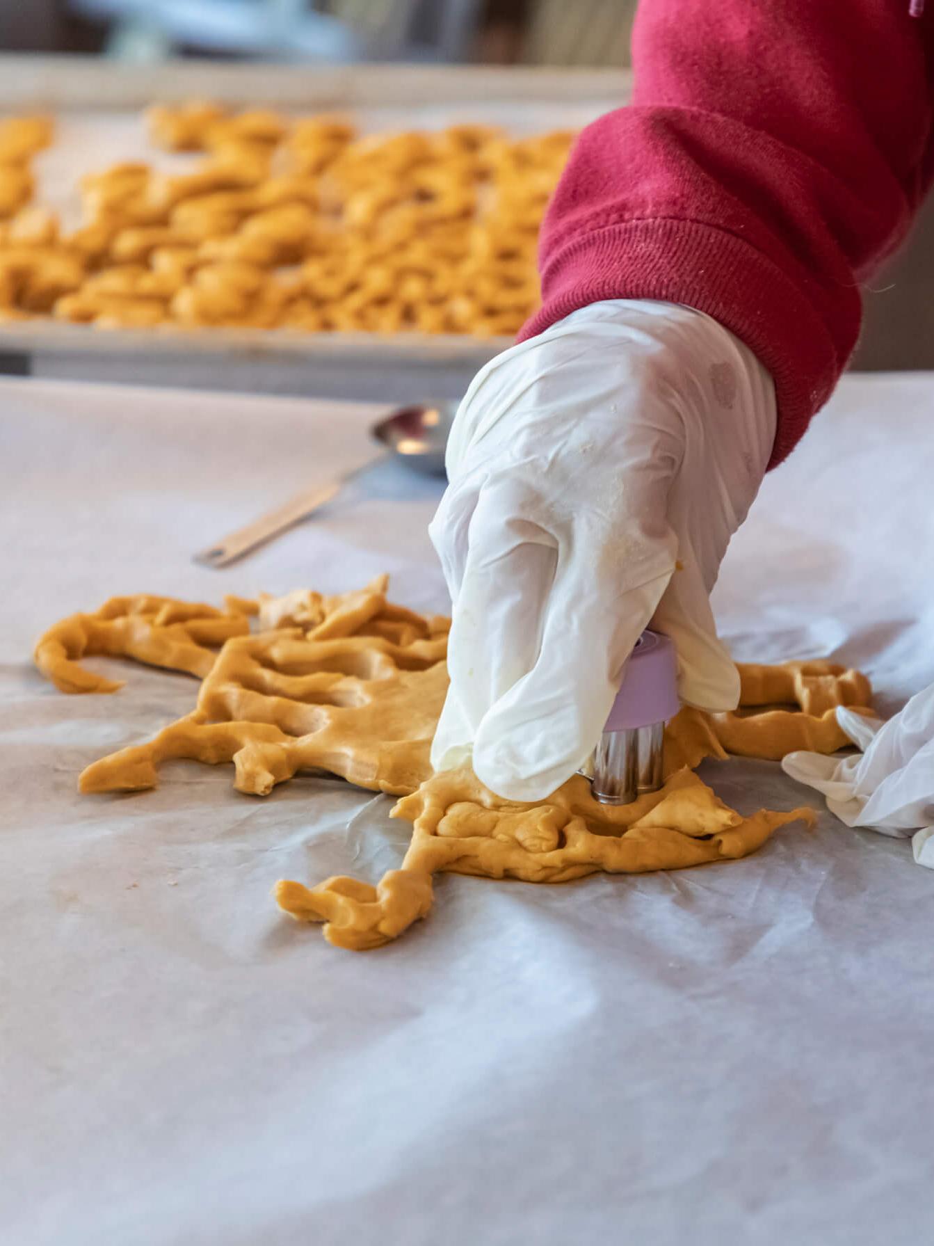 women cutting homemade dog treats