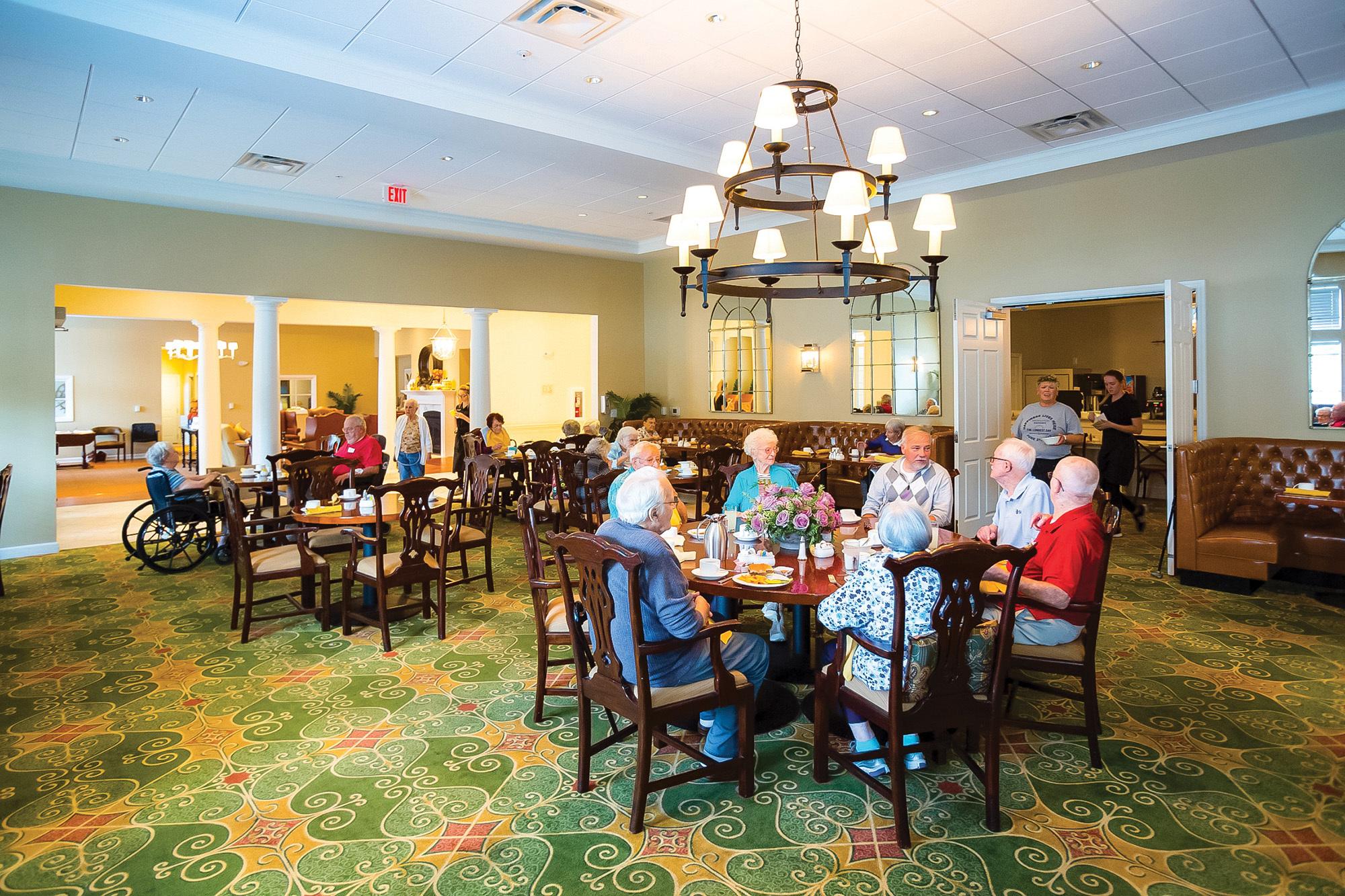 People seated at tables in a spacious dining area with a cozy and inviting atmosphere.