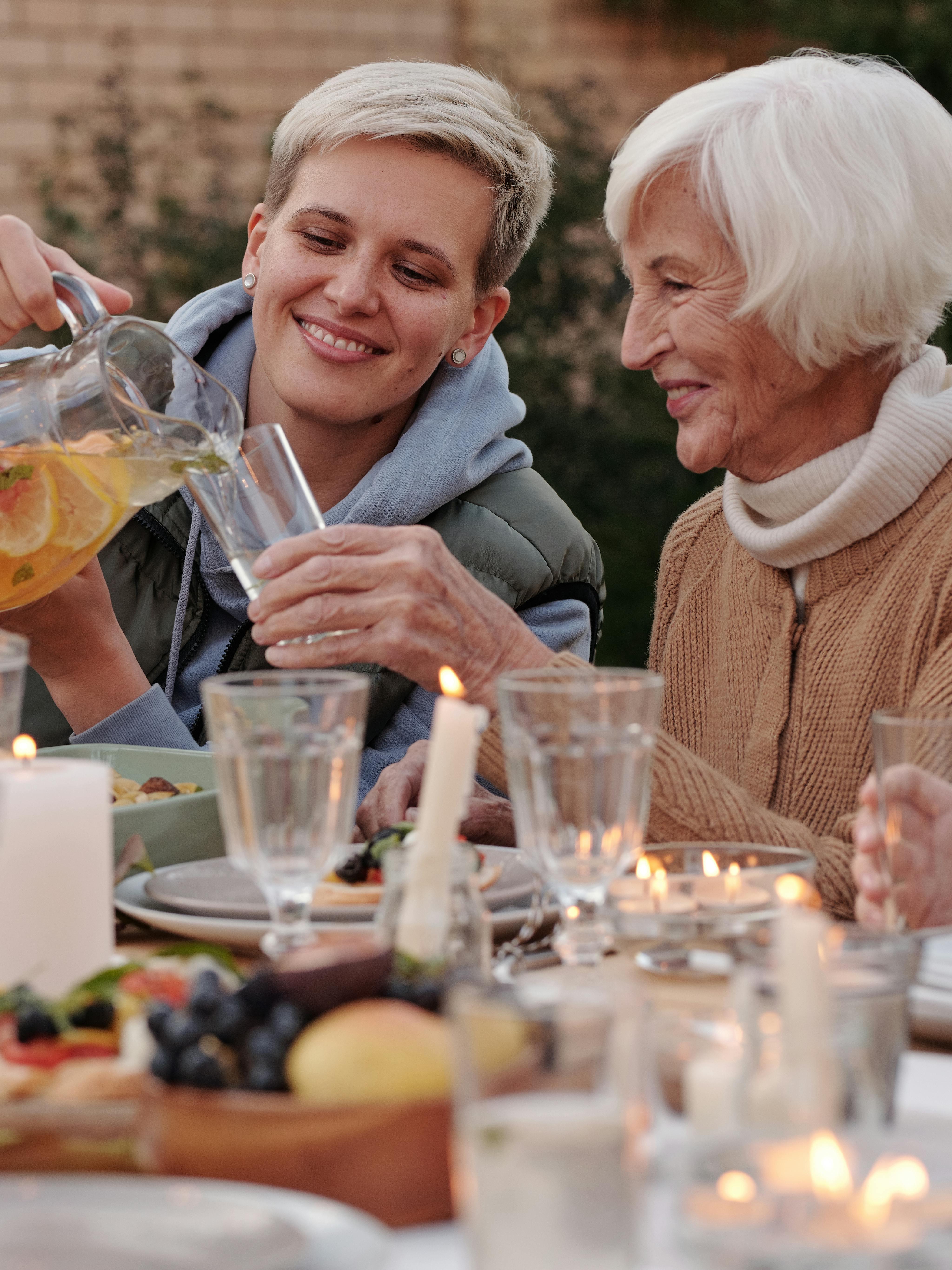 two women, one pouring the other a drink